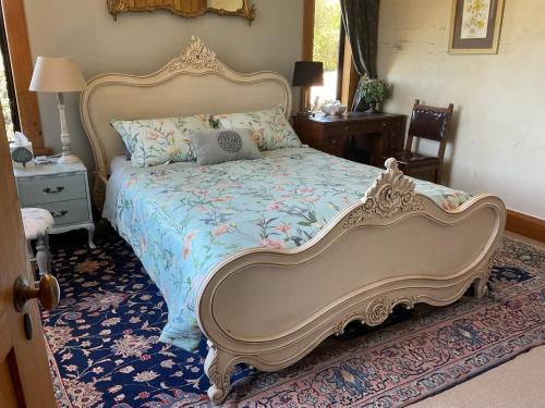 a bedroom with a large bed with a blue comforter at Redwood Valley B & B in Richmond