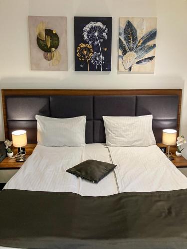 a bedroom with a bed with a black and white comforter at Zoned MASLAČAK lux - SPA & Wellness Kopaonik in Kopaonik