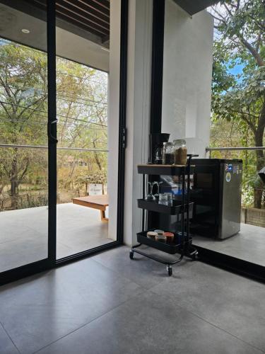 a room with a large glass door and a television at Mystica in Playa Avellana