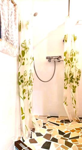 a bathroom with a shower with a checkered floor at Art Bungalow Amami in Amami