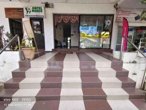 a building with a checkered floor in front of a store at Hotel Remix 2 Cameron Highlands in Brinchang