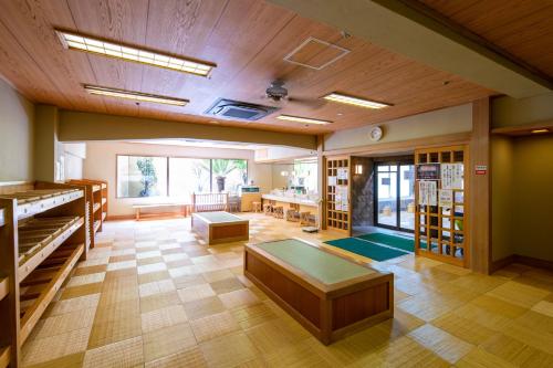 a large room with a piano and a table at Mt Fuji Hanayagi no Sho Keizan in Fuefuki