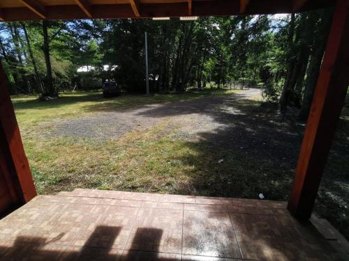 an open door to a yard with a driveway at Cabañas El Rincón De Huallerupe in Melipeuco