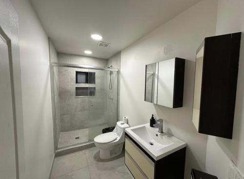 a bathroom with a toilet and a sink and a shower at Garden and chill in Tijuana