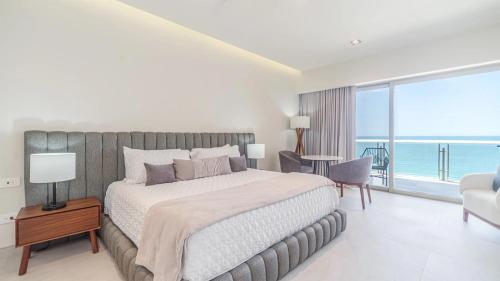 a bedroom with a bed and a view of the ocean at Two bedroom Suite in Puerto Peñasco