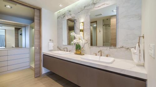 a bathroom with two sinks and two mirrors at Two bedroom Suite in Puerto Peñasco