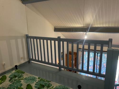 a room with a balcony with a bed and a window at APPARTEMENT LOTUS avec PISCINE et à 3 min de la PLAGE Pointe Marin in Sainte-Anne