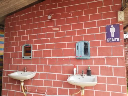 a brick wall with two sinks in front of it at Camping At Pawana in Malavli