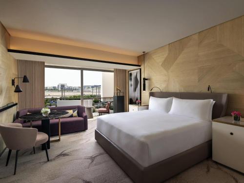 una camera da letto con un letto grande e un soggiorno di Rixos Gulf Hotel Doha a Doha