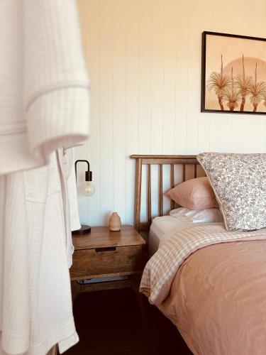 a bedroom with two beds and a table with a lamp at Hilltop Haven Darlington in Darlington