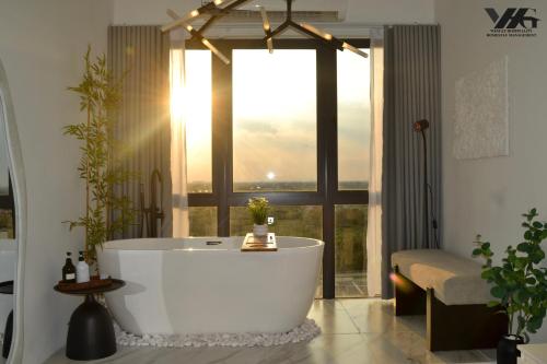 a bath tub in a bathroom with a large window at Core Soho Designer Suite @ KLIA in Sepang