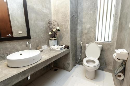 a bathroom with a sink and a toilet at Ketawa Pet Friendly Hotel in Chiang Mai