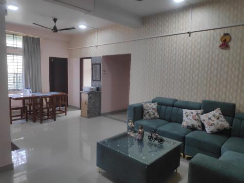 a living room with a couch and a table at The Siiying in Pāsighāt