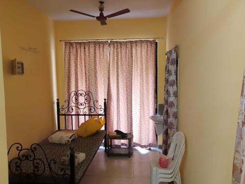 a living room with a couch in front of a window at Surabhi Gardenia 28B-C in Raichak