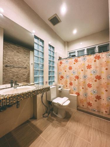 a bathroom with a toilet and a sink and a shower at Watermill Resort in Nong Nam Daeng