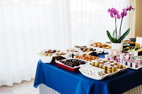 a blue table with different types of pastries on it at Hotel Santa Anna in L'Estartit