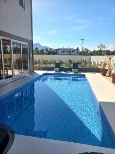 a swimming pool with blue water in a house at Beachfront With 2 Bedrooms and Pool for 20 in San Juan