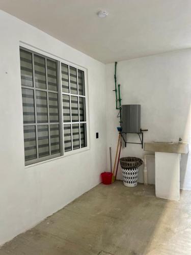 a white room with a window and a concrete floor at Moderno departamento en Tula in Tula de Allende