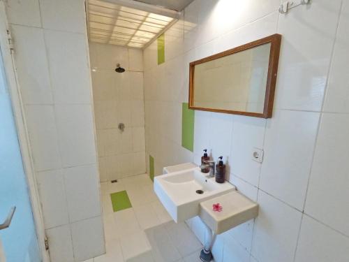 a white bathroom with a sink and a shower at Villa PhyPhy in Gili Trawangan
