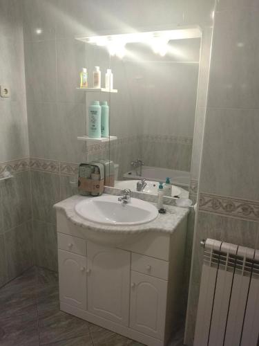 a bathroom with a sink and a mirror at apartment with 5 bedrooms in Bragança