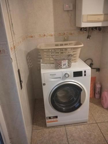 a washing machine with a basket on top of it at apartment with 5 bedrooms in Bragança