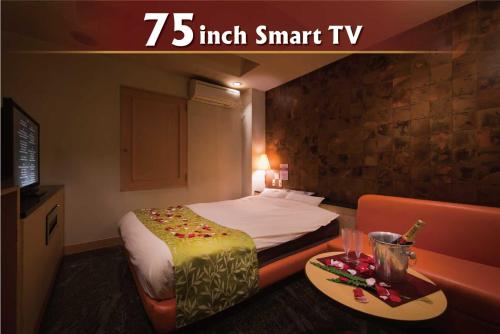a small hotel room with a bed and a table at Hotel Will池袋 Adult Only in Tokyo