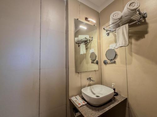 a bathroom with a sink and a shower at Zip by Spree Hotels Shirdi - Walkable Distance from Sai Baba Temple in Shirdi