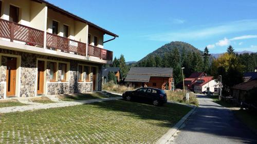 a black car parked in front of a building at Apartmán č. 8 Skalka in Donovaly
