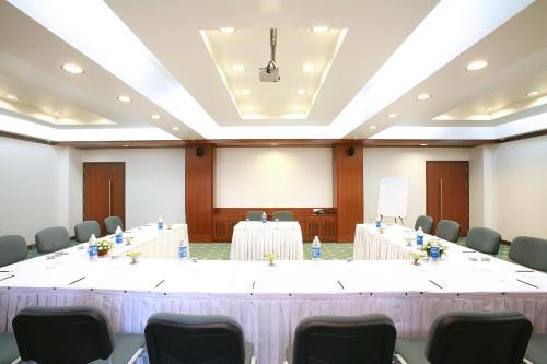 a large meeting room with tables and chairs at E Square The Fern, Pune in Pune