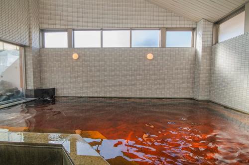 a large room with a floor filled with koi at ART HOTEL Kashima Central in Kamisu