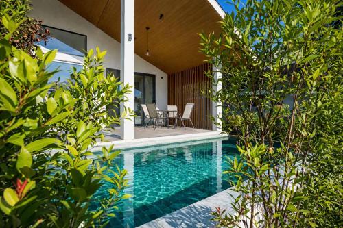 a swimming pool in the backyard of a house at Cocolane Villa 4 in Hinkong