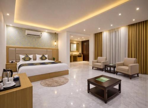 a hotel room with a bed and a desk at Hotel Decent Suites - Delhi Airport in New Delhi
