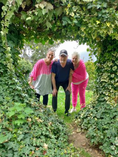 a group of three people standing in a tunnel of plants at EifelTörchen in Kirchheim