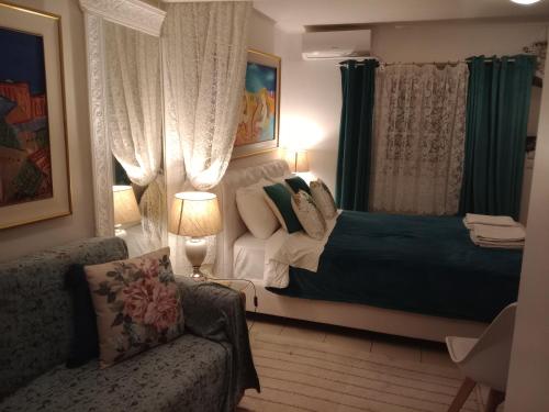 a bedroom with a bed and a couch at Metropolis studio in Corfu