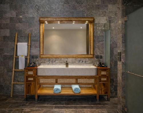 a bathroom with a sink and a mirror at Kappa Senses Zanzibar in Pwani Mchangani