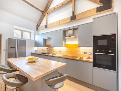 a kitchen with a wooden table and a counter top at Arenig View - Uk51068 in Frongoch