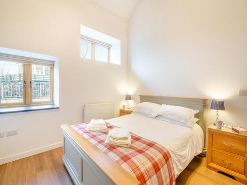 a bedroom with a bed and two windows at Arenig View - Uk51068 in Frongoch