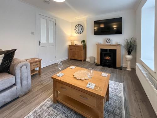 a living room with a couch and a table at Taigh-Beag - Uk50660 in Wigtown