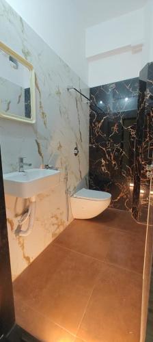 a bathroom with a sink and a toilet at Vijaya Inn in Visakhapatnam
