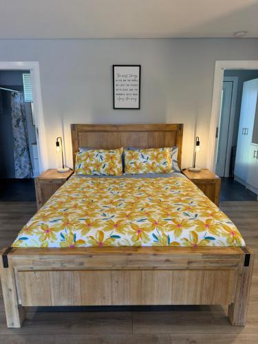 a large bed in a room with two night stands at Boyanup West Wing in Boyanup