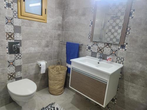 a bathroom with a toilet and a sink at Jasmin Prestige Duplex - Hammamet in Hammamet