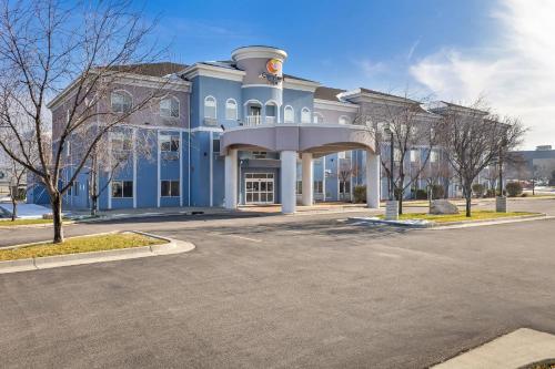 a blue and white building with a parking lot at Comfort Inn Ogden near Event Center in Ogden