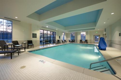 a pool in a hotel lobby with chairs and tables at Homewood Suites by Hilton Atlanta Buckhead Pharr Road in Atlanta