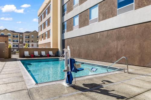 a swimming pool with a slide next to a building at Home2 Suites By Hilton New Braunfels in New Braunfels