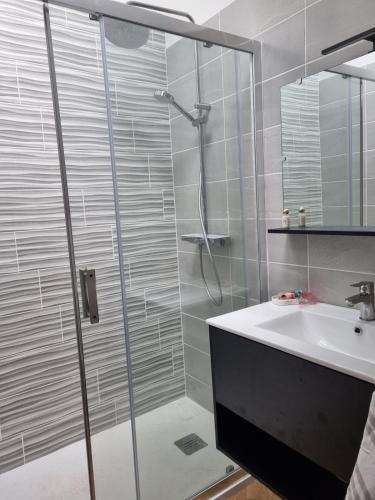 a bathroom with a shower and a sink at Zen suite Moulin de Vilaine in Châteauroux