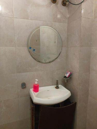 a bathroom with a sink and a mirror at Hotel Surya in Datia