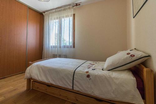 a bedroom with a bed with a pillow on it at Le mas clair in Pins-Justaret