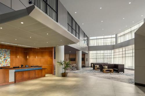 a lobby of a building with desks and chairs at Hilton Baltimore BWI Airport in Linthicum Heights