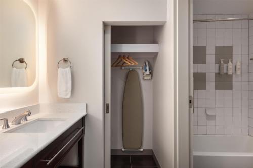 a bathroom with a shower and a toilet and a sink at Homewood Suites TechRidge Parmer @ I-35 in Austin