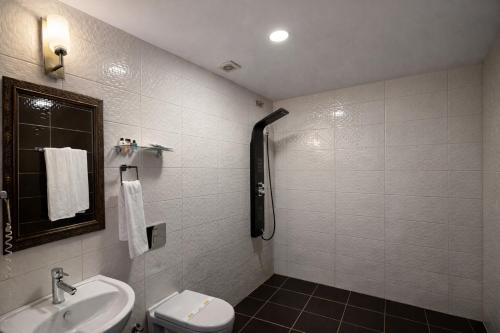a bathroom with a sink and a toilet at Osmanli Marco Pasha Hotel in Tarsus